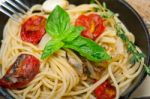 Spaghetti Pasta With Baked Cherry Tomatoes And Basil Stock Photo