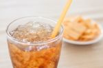 A Glass Of Cola With Snack On White Plate Stock Photo