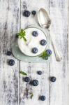 Glass Of Yogurt With Fresh Blueberries Stock Photo