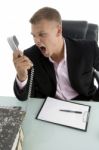 Angry Employee Shouting On Phone Stock Photo