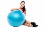 Woman In Gym Relaxing Beside Exercise Ball Stock Photo