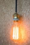 Vintage Hanging Light Bulb Decorated On Brown Wall Stock Photo