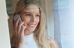 Young Beautiful Woman Using Her Mobile Phone At Home Stock Photo