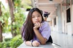 Portrait Of Thai High School Student Uniform Teen Beautiful Girl Using Her Phone And Smile Stock Photo