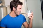 Man Liking Milk Stock Photo