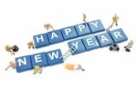 Miniature Worker Team Building Word Happy New Year On White Background Stock Photo