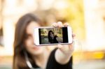 Young  Woman Taking A Photo With Her Phone Stock Photo