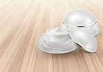 White Rounded Cosmetic Jar On Wood Background Stock Photo