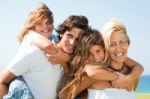 Parents Giving Piggyback Rides  Stock Photo