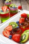 Red And Green Jelly Served With Fruit Stock Photo