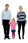 Cute Daughter Holding Hands Of Her Parents Tightly Stock Photo