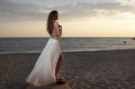 Women On The Beach Watching Sunset Stock Photo