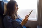 Beautiful Young Woman Reading A Book In The Train Stock Photo