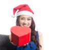 Young Women Wearing Christmas Hats Stock Photo