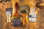 Oil Paint Brushes On Wood Painted Background Stock Photo