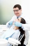 Male Dentist Attending His Patient Stock Photo