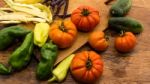 Several Vegetables On Wooden Chopping Board And Table Stock Photo