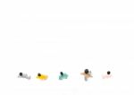 Group Of Miniature People Standing On White Background Stock Photo