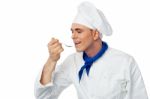 Male Chef Tasting The Food Stock Photo