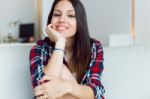 Beautiful Young Woman Looking At Camera At Home Stock Photo