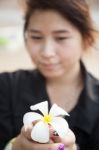 Asian Women Black Shirt. Holding White Flower Stock Photo