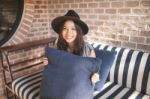 Woman Smiling Near Rustic Brick Wall Stock Photo