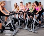 Group Of People Doing Exercise On A Bike Stock Photo