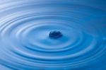 Water Drop Impact With Water Surface, Causing Rings On The Surface Stock Photo