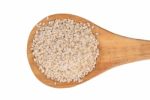 Sesame Seeds With Wooden Spoon On A White Background Stock Photo