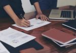 Woman Standing And Writing Document Hand Close Up At Desk Stock Photo