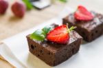 Chocolate Brownie Cake Decorated With Strawberries. Selective Fo Stock Photo