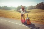 Hippie Girl Hitchhiking Stock Photo