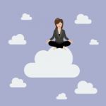 Business Woman Meditating On A Cloud Stock Photo