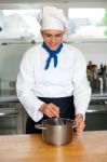 Young Male Chef With Whisk And Mixing Bowl Stock Photo