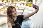 Woman Sitting  And Making Selfie Stock Photo