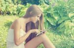 Beautiful Woman With Tablet Computer In Park Garden Stock Photo