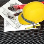 Yellow Hard Hat On Blueprint Stock Photo