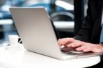 Cropped Image Of Man Working On Laptop Stock Photo