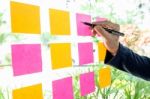 Close Up Shot Of Hands Of Woman Sticking Adhesive Notes On Glass Stock Photo