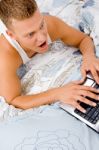 Man Working On Laptop At Home Stock Photo