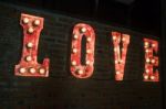 Love Bulb Sign Decorated On Brick Wall Stock Photo