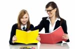 Educator Sitting With A Student And Taking Her Through A Lesson Stock Photo