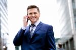 Smiling Man In Suit Talking On Cell Phone Stock Photo