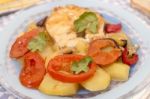 Fish With Potatoes And Tomato Stock Photo