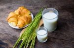 Croissant On Dish With Rice Milk And Ear Of Rice  On Old Wooden Stock Photo