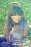 Beautiful Woman With Tablet Computer In Park Stock Photo