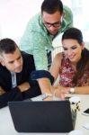 Casual Executives Working Together At A Meeting With Laptop Stock Photo