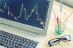 Stock Or Forex Graph In Laptop Screen On Blue Vintage Style Stock Photo