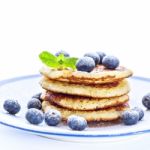 Pile Of Pancakes With Blueberries Sprinkled With Icing Sugar Stock Photo