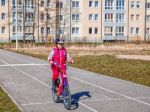 Little Girl In A Safety Helmet Riding A Bicycle Stock Photo